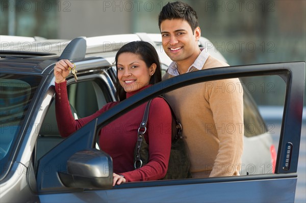 Couple with new car.