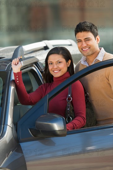 Couple with new car.