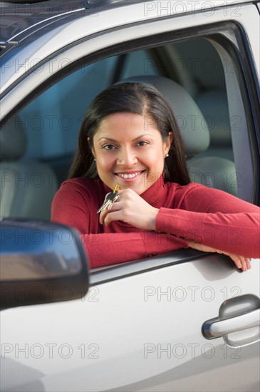 Woman sitting in her new car.