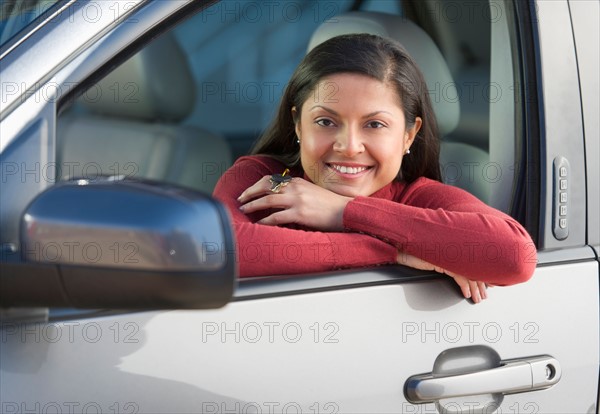 Woman sitting in her new car.