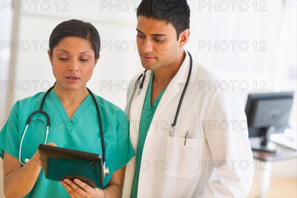 Doctors using digital tablet.