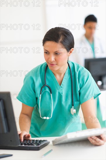 Doctors working on computers.