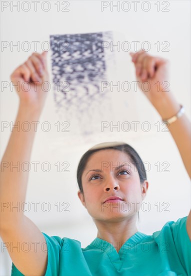 Doctor examining medical record.