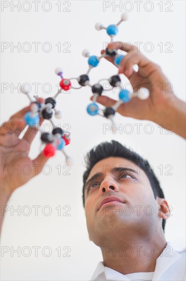 Man holding molecular model.