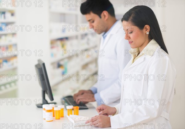 Two pharmacists in pharmacy.