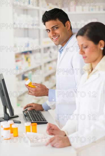 Two pharmacists in pharmacy.