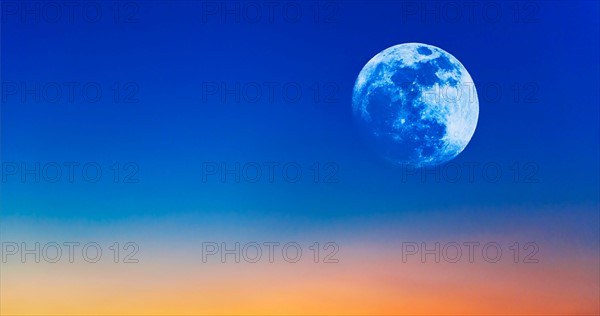 Full moon on evening sky.