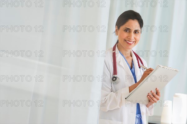 Doctor filling medical document.