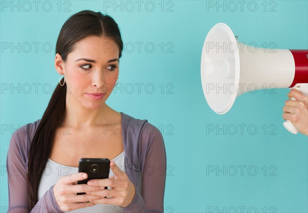 Studio shot of woman texting.