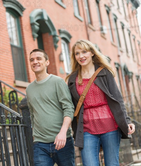 Couple walking on street.