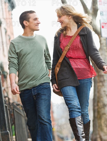 Couple walking on street.