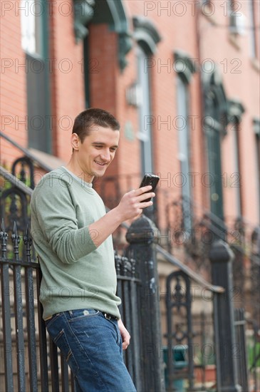 Man using smart phone on street.