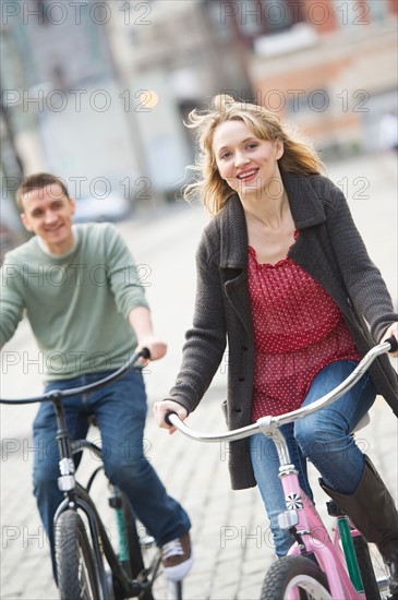 Couple cycling on street.