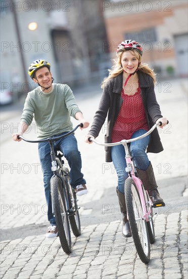 Couple cycling on street.