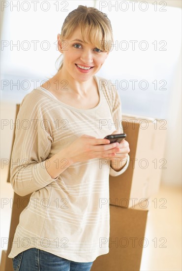 Woman using smart phone during relocation.