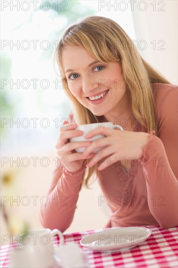 Portrait of woman sitting at table.