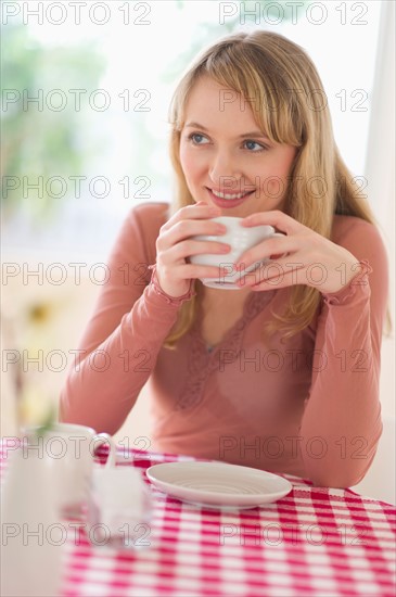 Portrait of woman sitting at table.
