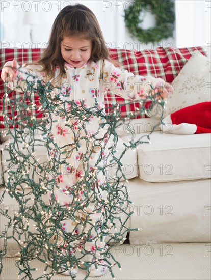 Small girl  (4-5 years) preparing Christmas lights. Photo : Jamie Grill