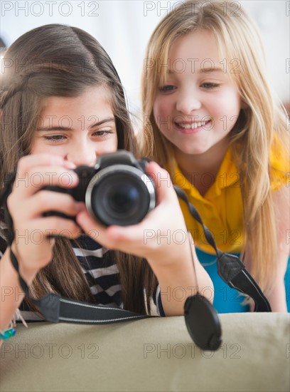 Close up of two girls using camera. Photo : Jamie Grill