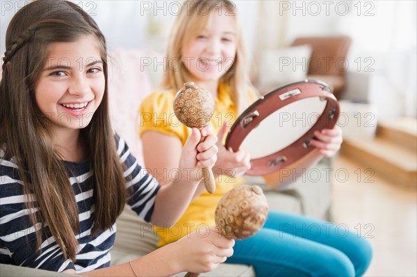 Two girls playing music on instruments. Photo : Jamie Grill