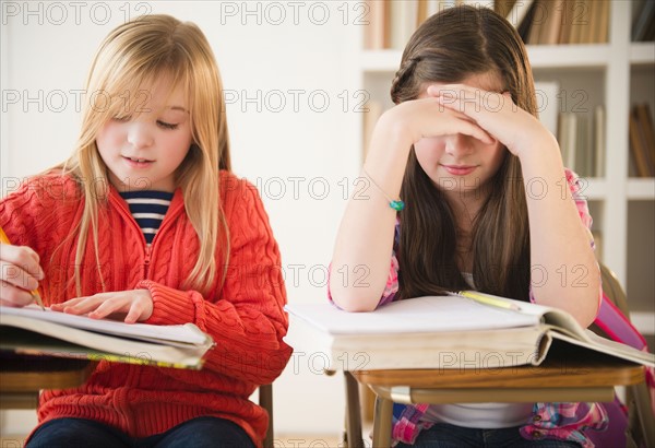 Two girls learning in classroom. Photo : Jamie Grill