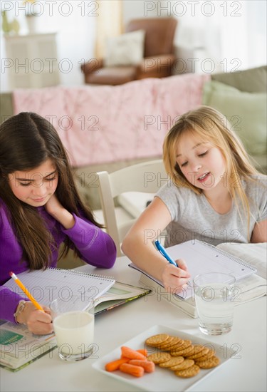 Two girls doing homework. Photo : Jamie Grill