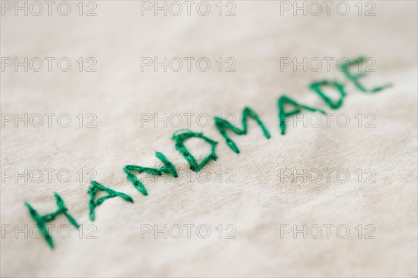 Close up of embroided handmade word, studio shot. Photo : Jamie Grill