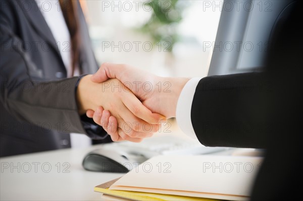 Close up of business people's shaking hands. Photo : Jamie Grill