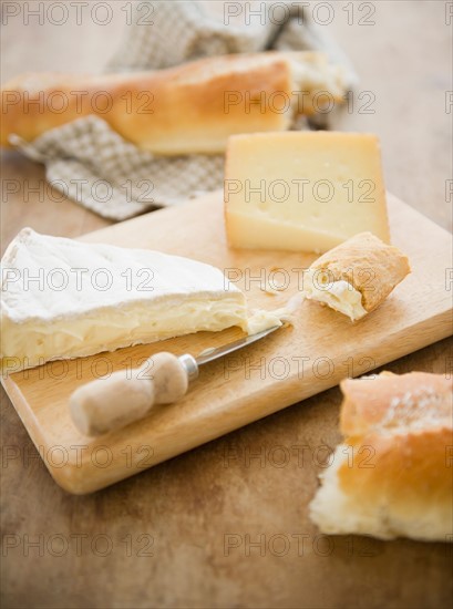 Close up of cheese and baguette on table, studio shot. Photo : Jamie Grill