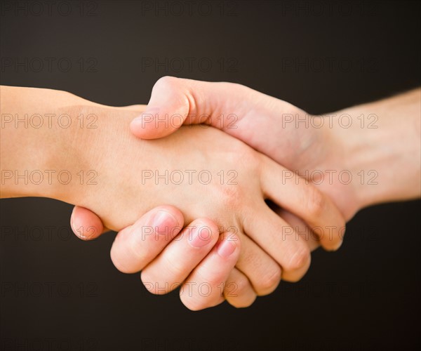 Close up of handshake,  studio shot. Photo : Jamie Grill