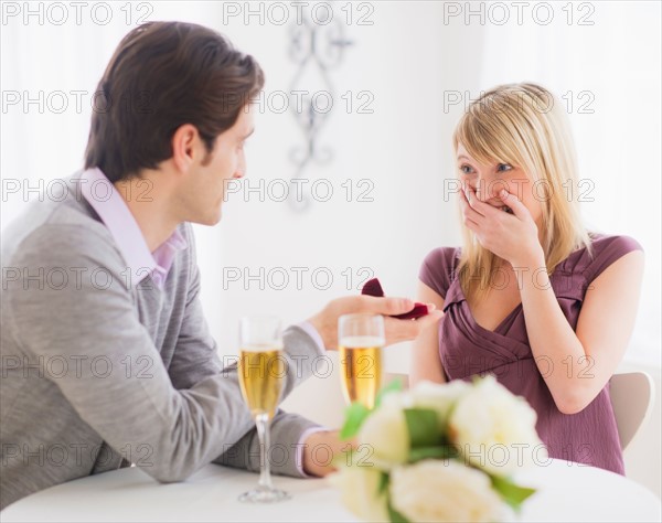 Couple celebrating engagement in restaurant. Photo : Daniel Grill