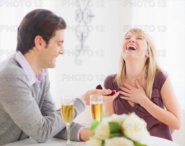 Couple celebrating engagement in restaurant. Photo : Daniel Grill