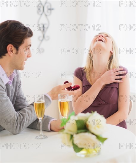 Couple celebrating engagement in restaurant. Photo : Daniel Grill