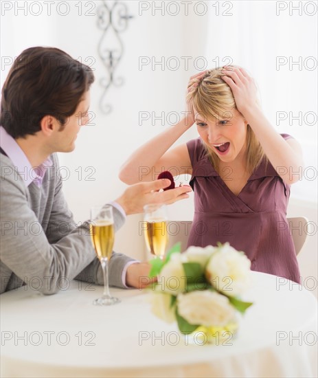 Couple celebrating engagement in restaurant. Photo : Daniel Grill