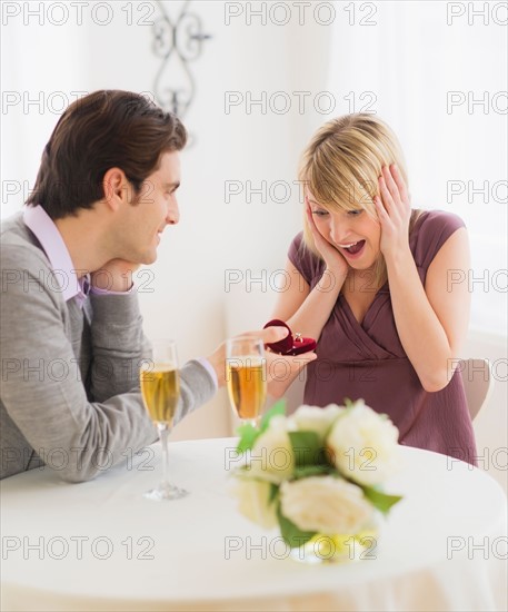 Couple celebrating engagement in restaurant. Photo : Daniel Grill