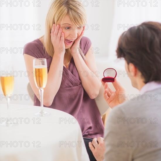 Couple celebrating engagement in restaurant. Photo : Daniel Grill