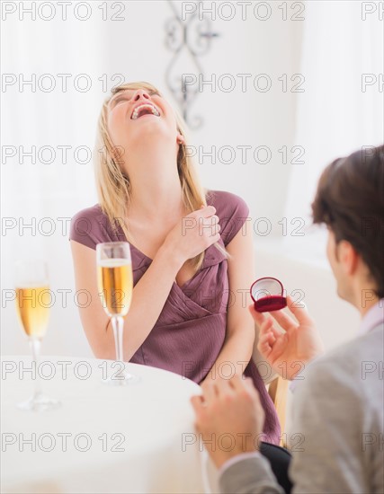 Couple celebrating engagement in restaurant. Photo : Daniel Grill