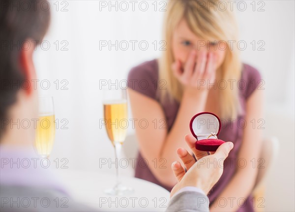 Couple celebrating engagement in restaurant. Photo : Daniel Grill