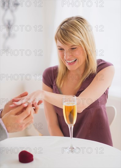 Couple celebrating engagement in restaurant. Photo : Daniel Grill