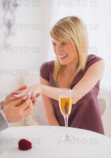 Couple celebrating engagement in restaurant. Photo : Daniel Grill