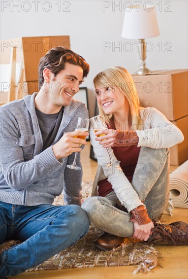 Couple making toast sitting on floor. Photo : Daniel Grill