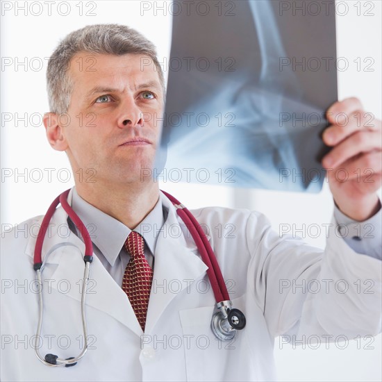 Portrait of doctor looking at x-ray image. Photo : Daniel Grill