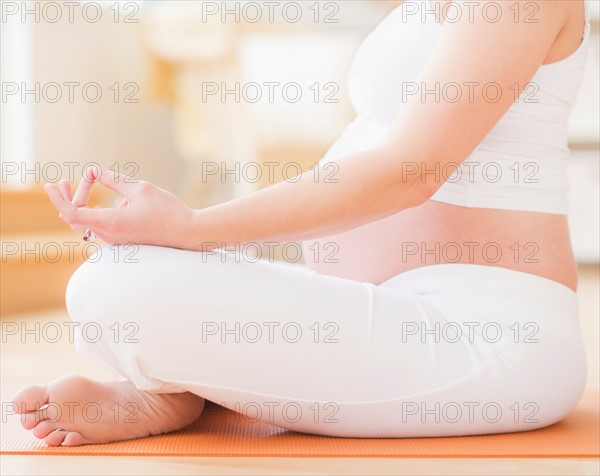 Pregnant woman practicing yoga. Photo : Daniel Grill