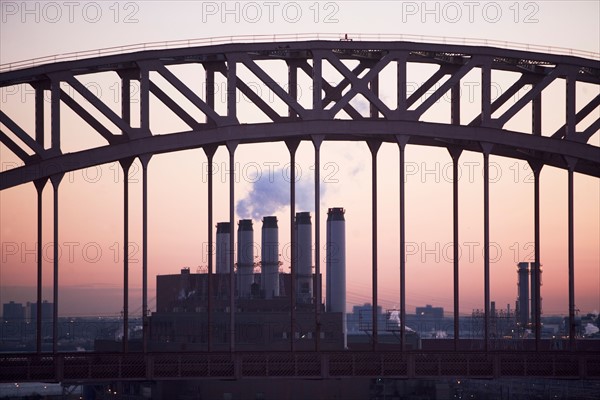 USA, New York, New York City. Bridge and smoke stacks at dusk. Photo : fotog