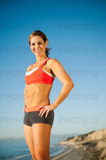 USA, California, San Diego. Woman training on coast.