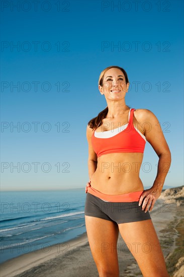 USA, California, San Diego. Woman training on coast.