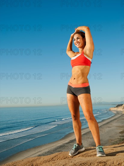 USA, California, San Diego. Woman training on coast.