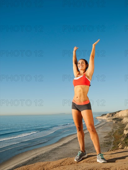 USA, California, San Diego. Woman training on coast.