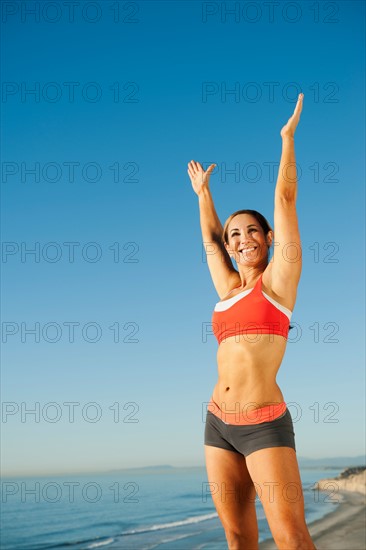 USA, California, San Diego. Woman training on coast.