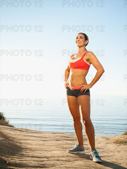 USA, California, San Diego. Woman training on coast.